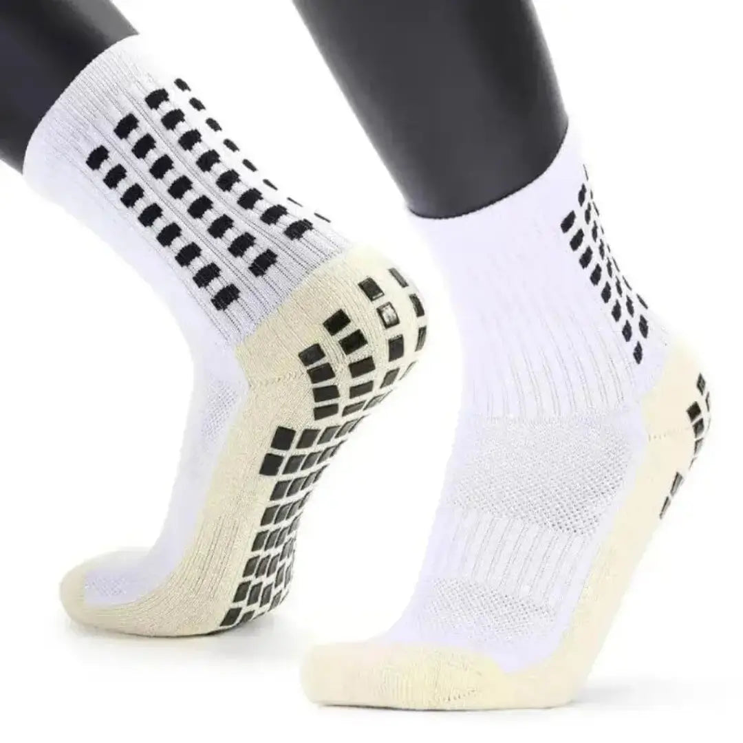 Gráfico explicativo de las medias grip socks mostrando el talón amortiguado y los paneles de absorción de impactos para proteger el pie.