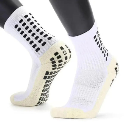 Gráfico explicativo de las medias grip socks mostrando el talón amortiguado y los paneles de absorción de impactos para proteger el pie.